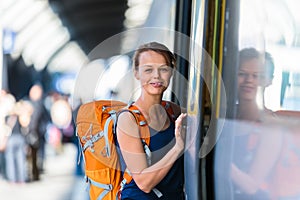 Pretty, young woman in a trainstation, waiting for her train