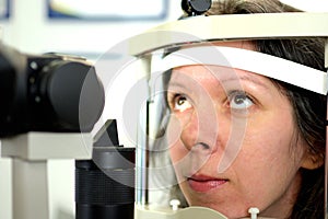 Pretty young woman undergone an ocular fundus inspection with ophthalmologist photo