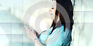 Pretty young woman using her mobile phone in the street, light effect, geometric pattern