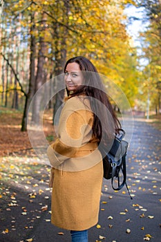 Pretty Young Woman Walking in Autumn Park Leaves Fall Relax Leisure Fashion Modern Golden Yellow