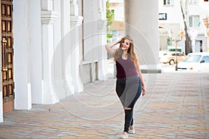 Pretty young woman walking on the city street. Casual fashion, plus size model. xxl women on nature.