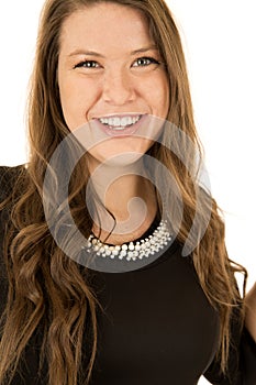 Pretty young woman wearing a black dress with pearls