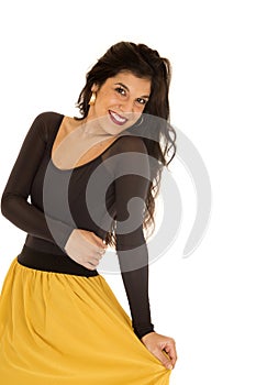 Pretty young woman wearing a black top and yellow skirt