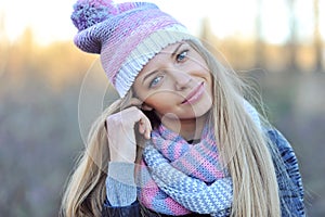 Pretty young woman wearing hat and scarf. Close up