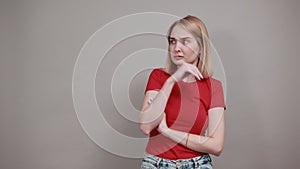 Pretty young woman wearing red shirt posing, sceptic shocked view