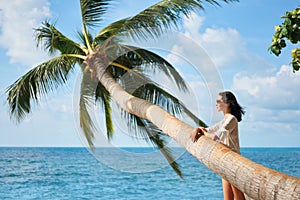 Pretty young woman in white bikini enjoy her tropical beach vacation
