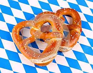 Pretzel in heart shape on white blue background