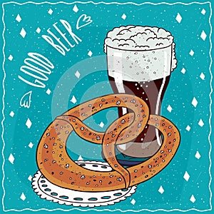 Pretzel or kringle with glass of stout or porter photo