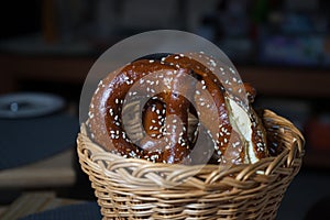 pretzel with sesame seeds in a wicker basket