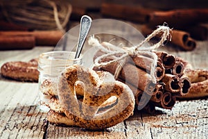 Pretzels with ground cinnamon, cinnamon sticks, brown cane sugar