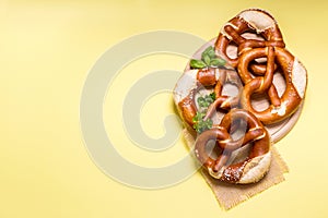 Pretzels on yellow background copy space, german traditional food
