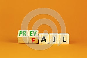 Prevail or fail symbol. Concept words Prevail or Fail on wooden cubes. Beautiful orange table orange background. Business prevail