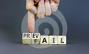 Prevail or fail symbol. Concept words Prevail or Fail on wooden cubes. Businessman hand. Beautiful grey table grey background.