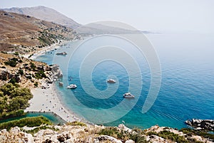 Preveli beach at Libyan sea, bay with ships and mountains , Crete , Greece