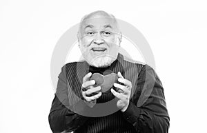 Preventing heart attack. Senior bald head bearded man holding red toy heart in hands. Mature man with valentines heart