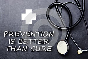 Prevention is better than cure text on chalkboard near medical object and symbols