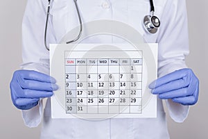 Prevention consultation concept. Cropped close up photo of person nurse holding calendar in hands isolated over grey color