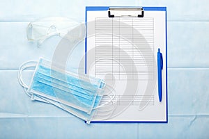 Prevention Coronovirus, Covid-19 test analysis form. Face surgical mask, medical documents, protective glasses on doctors