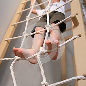 prevention of foot deformity in children, the child climbs on the gladiator& x27;s net, the concept of sport and health