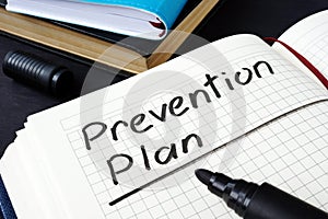 Prevention plan written in a note pad.