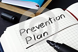 Prevention plan written in a note pad. photo