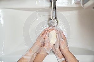 Prevention. dad teaches daughter washing hands.