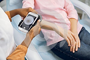 Preventive checkup, skin melanoma days concept. Close up of hands of female doctor dermatologist oncologist holding new