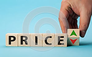 Price growth and decline. Hand changes the position of a block with symbols of growth and decline Price. Price regulator