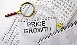 PRICE GROWTH text written on notebook on chart with keyboard and planning