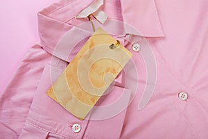 Price tag hang over pink shirt close up view - Image