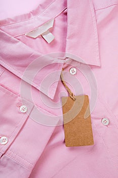 Price tag hang over pink shirt close up view - Image