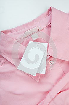 Price tag hang over pink shirt close up view - Image