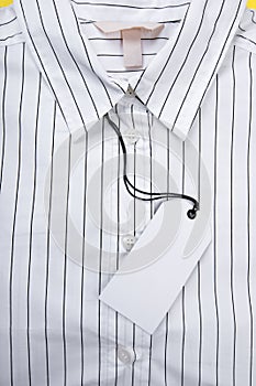 Price tag hang over white  shirt close up view- Image