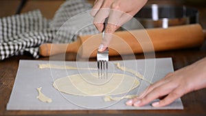 Pricking dough with fork. Making cake layers