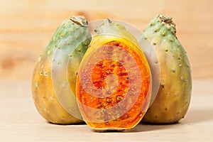 Prickly pear cactus fruits - Opuntia ficus indica; photo on wooden background