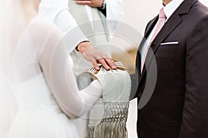 Priest blessing bride and groom