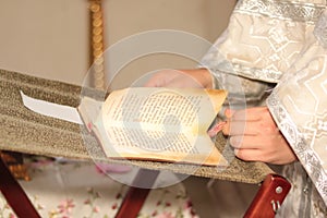 Priest in church reads prayer during religious rite