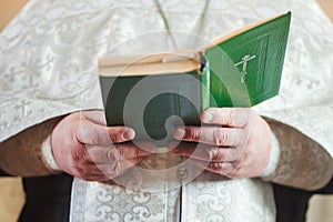 Priest in church reads photo