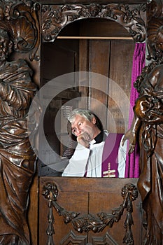 Priest in confession booth