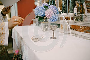 Priest consecrates the rings of the spouses inside the Church of Our Lady of the Rocks