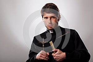 Priest with cross and holy bible