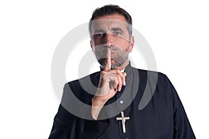 Priest with finger in lips as a silence