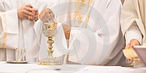 Priest` hands during a wedding ceremony/nuptial mass