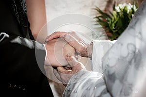 Priest holding hand blessing youg couple