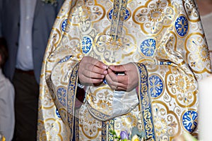 Priest holding a wedding ring during the marriage ceremony