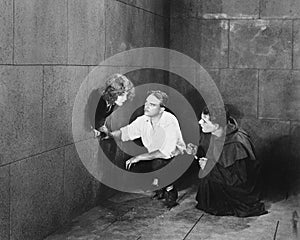 A priest and a man trying to help a young woman escape