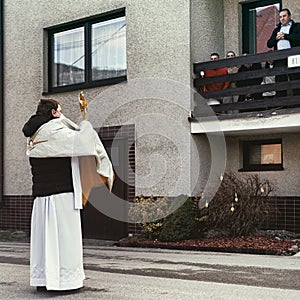 Priest with mask with eucharistic adoration on Easter sunday in village Martincek, Slovakia