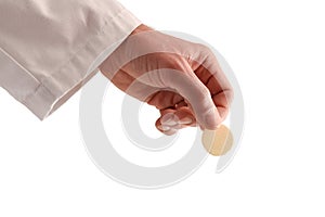Priest offering a consecrated host on a white isolated background photo