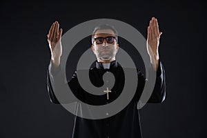 Priest open arms blessing praying God