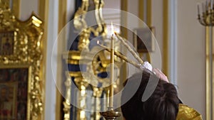 Priest praying in a cathedral, religious ceremony